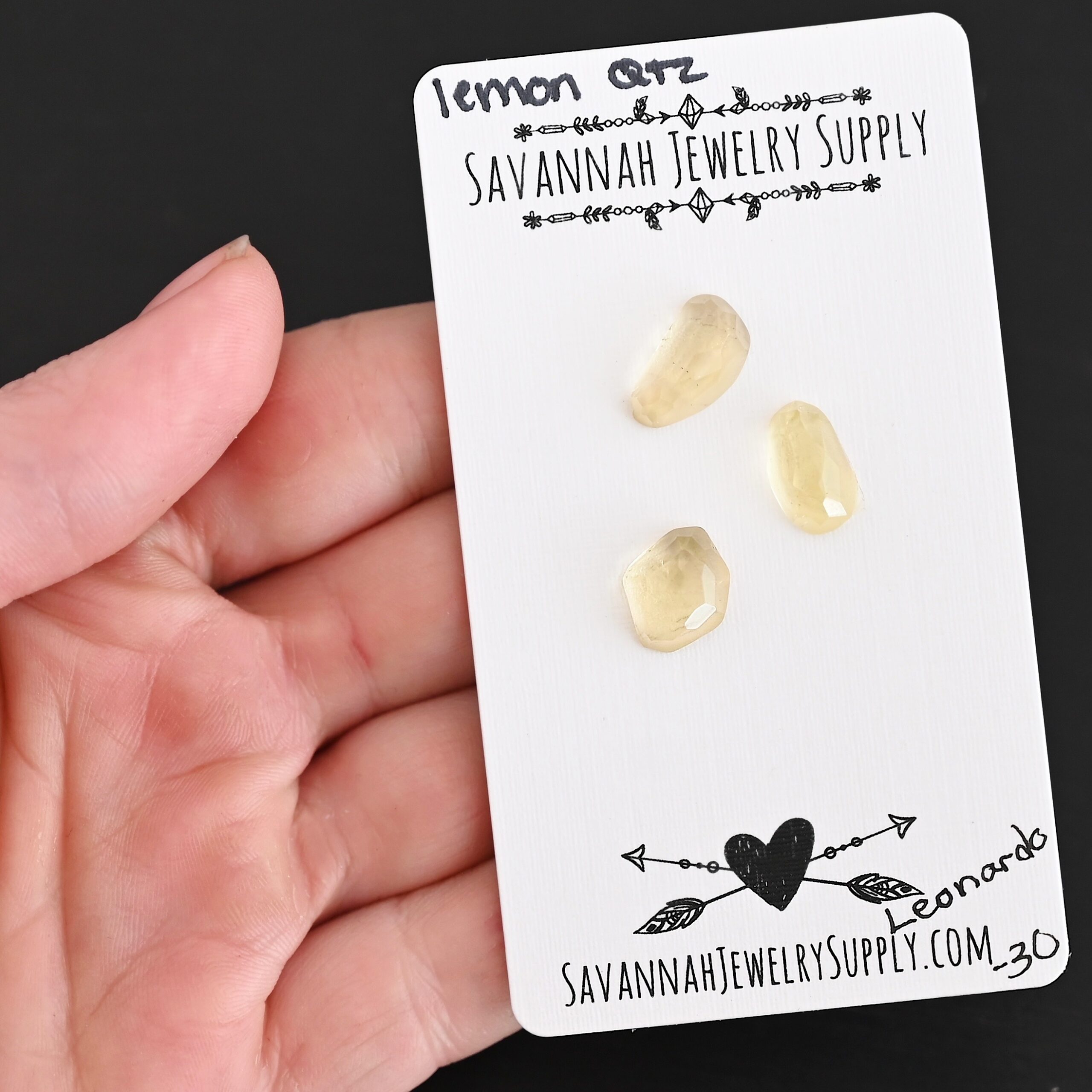 Leonardo Rose Cut Lemon Quartz Cabochon Parcel shown in hand