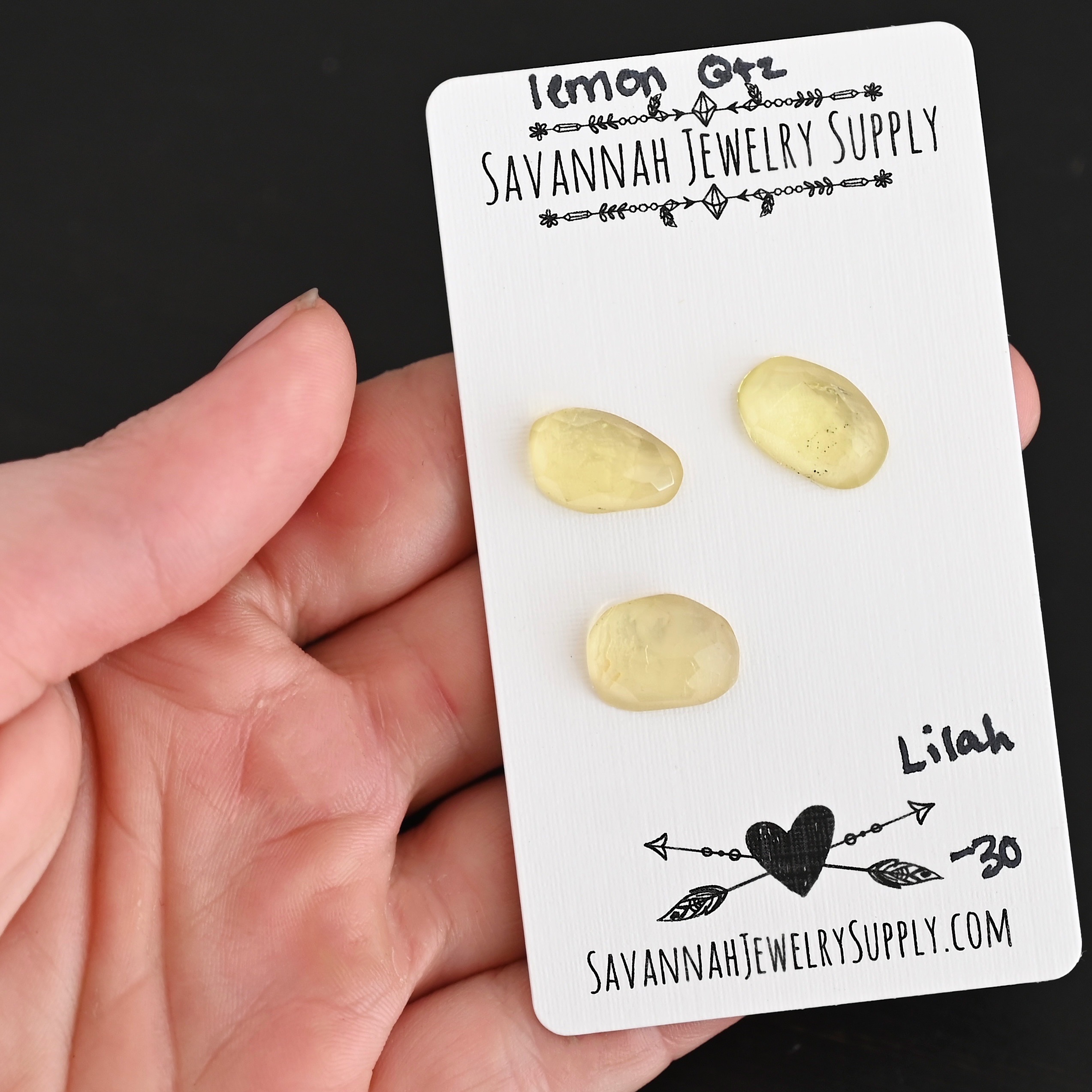 Lilah Rose Cut Lemon Quartz Cabochon Parcel shown in hand