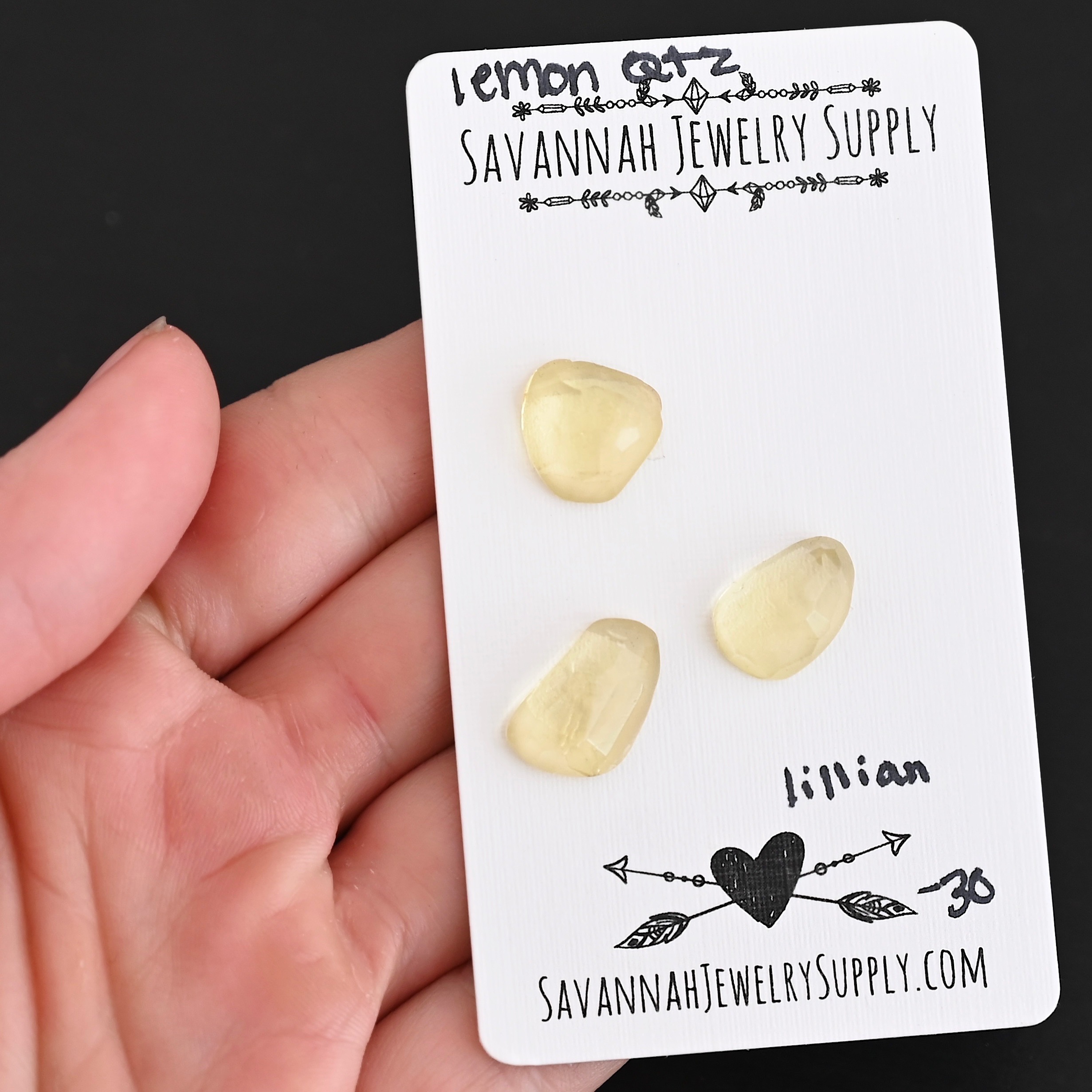 Lillian Rose Cut Lemon Quartz Cabochon Parcel shown in hand