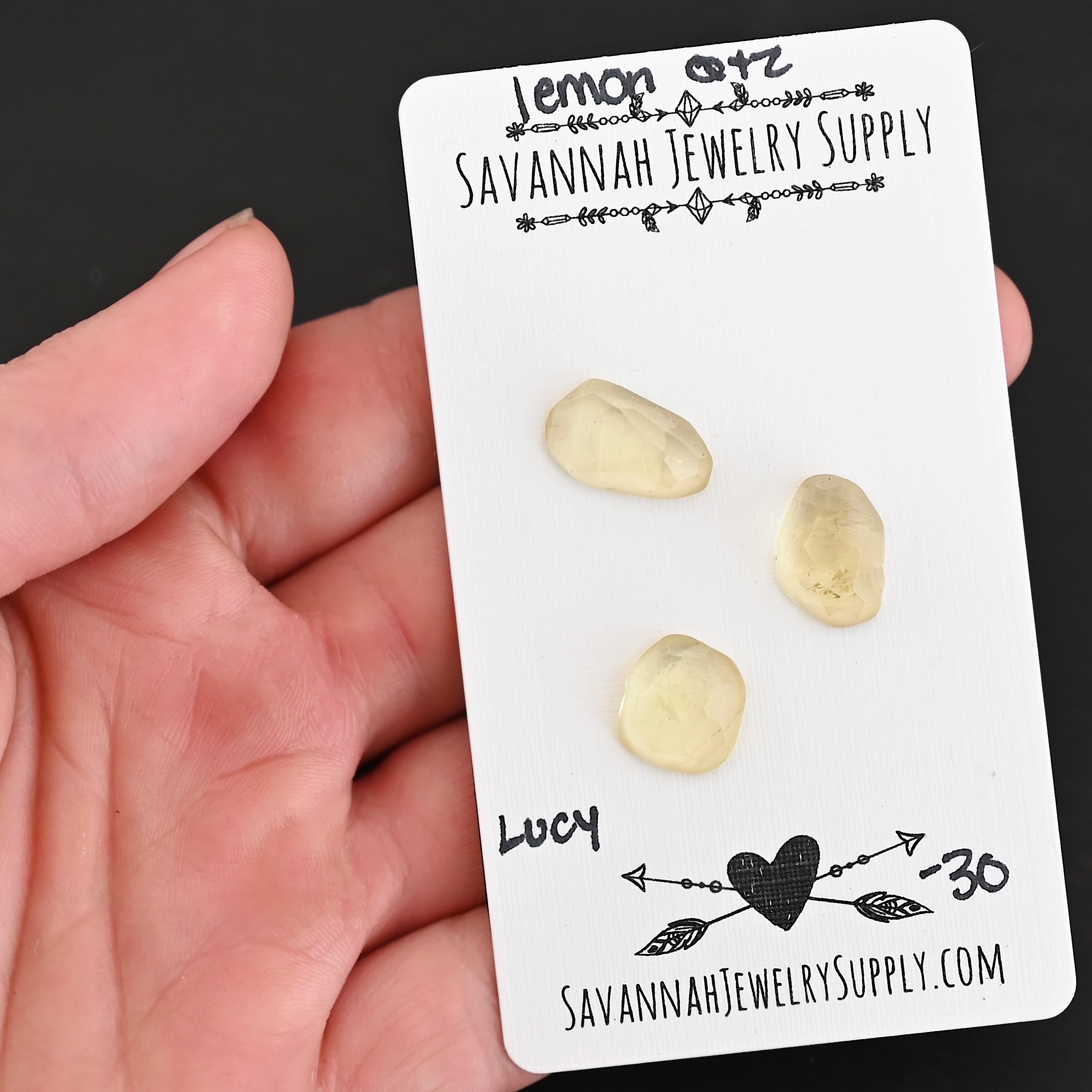 Lucy Rose Cut Lemon Quartz Cabochon Parcel shown in hand