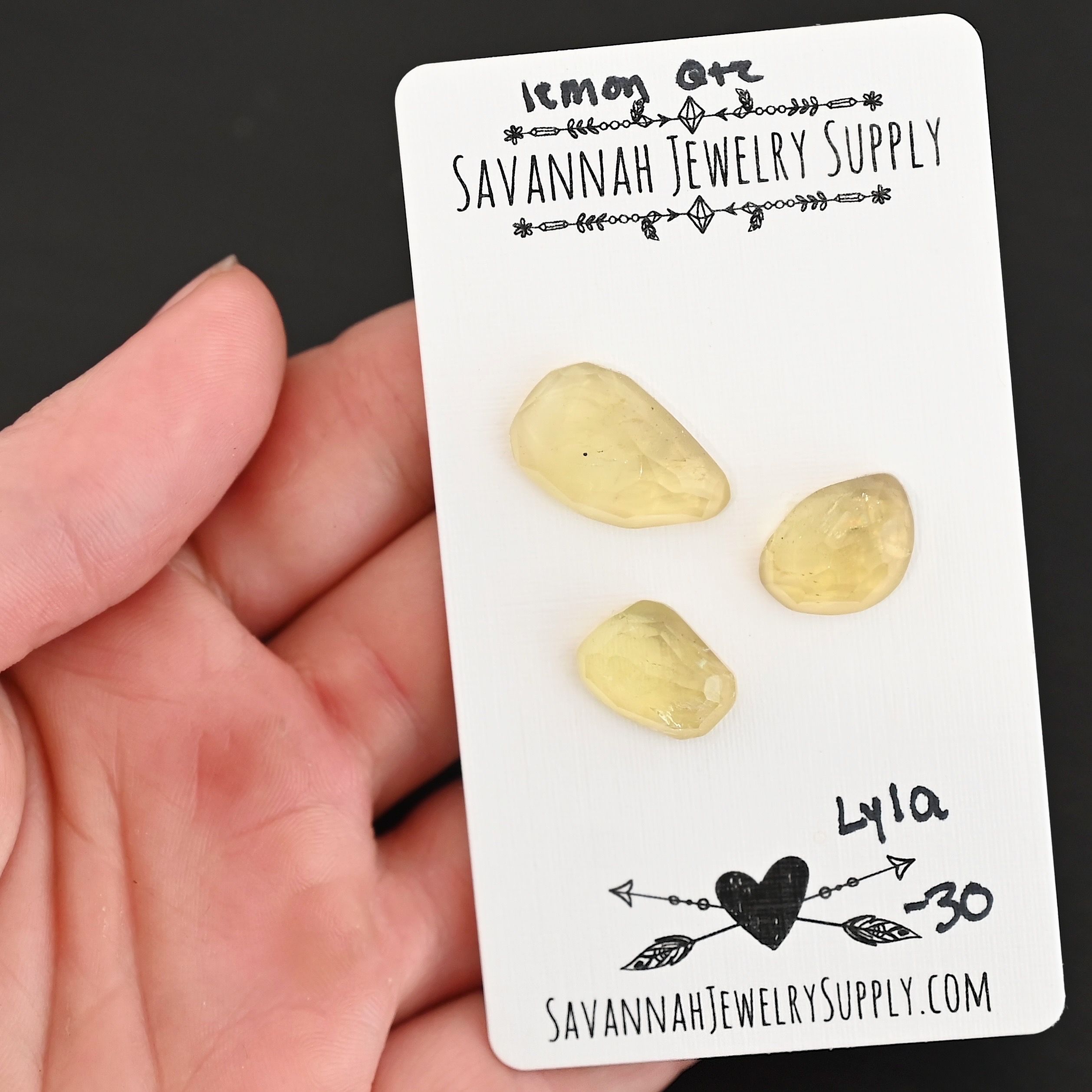 Lyla Rose Cut Lemon Quartz Cabochon Parcel shown in hand