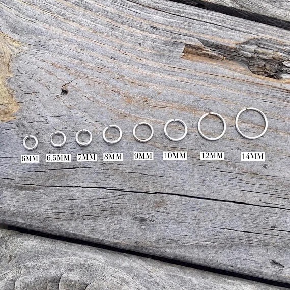 Seven jump rings labeled with mm and going from smallest to largest left to right.
